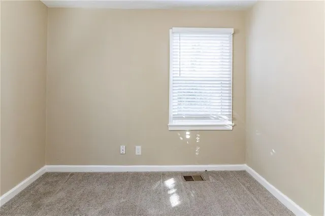 a view of a bathroom with a glass door and a window