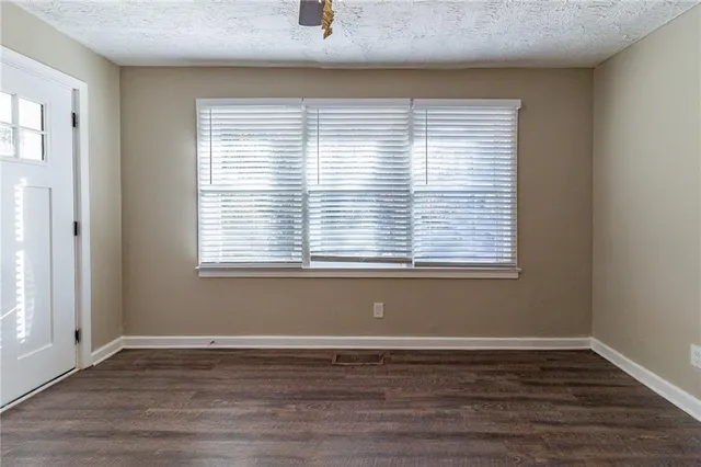 a view of a room with wooden floor and a window