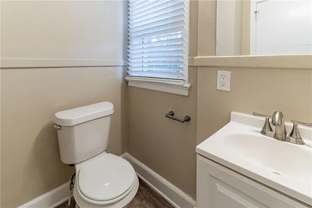 a white toilet sitting next to a bathroom sink
