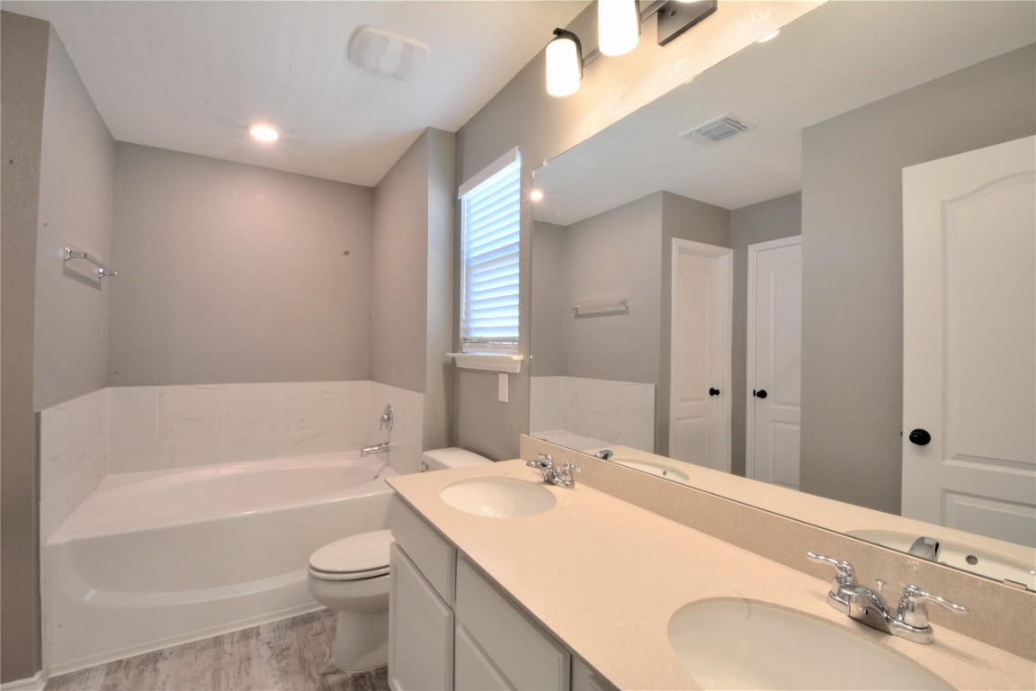 522 Thunder Valley Trail Georgetown, TX 78626 - Photo 16 of 24 a bathroom with a sink vanity granite toilet tub and shower