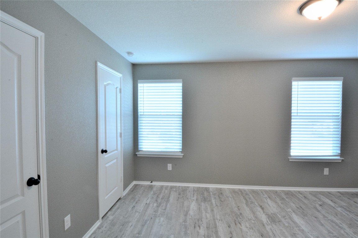 522 Thunder Valley Trail Georgetown, TX 78626 - Photo 20 of 24 a view of an empty room with wooden floor and a window