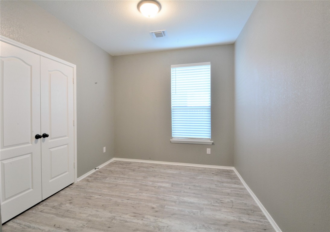 522 Thunder Valley Trail Georgetown, TX 78626 - Photo 4 of 24 a view of an empty room with wooden floor and a window