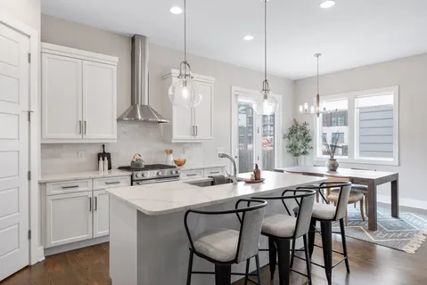 a kitchen with a table chairs stove and cabinets