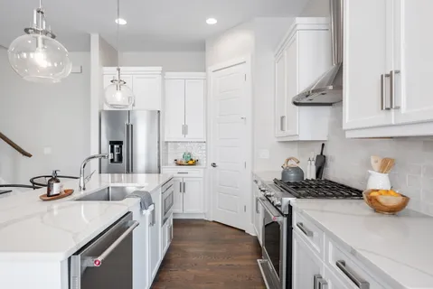 a kitchen with stainless steel appliances a sink stove and refrigerator