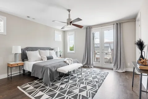 a bedroom with a large bed and a window