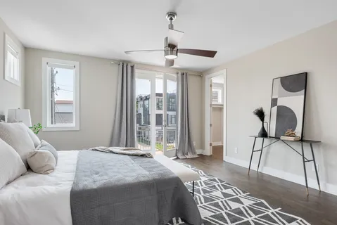 a bedroom with a bed a window and glass door