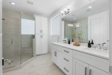a bathroom with a shower sink double and mirror