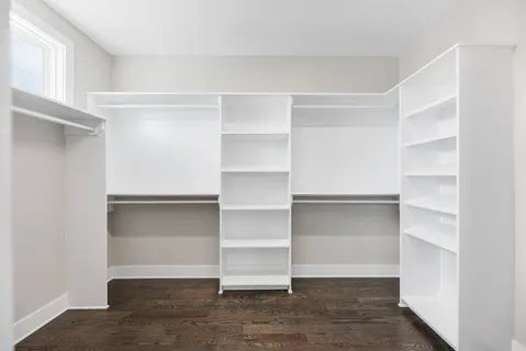 a view of walk in closet with empty racks