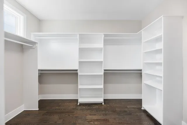 a view of walk in closet with empty racks