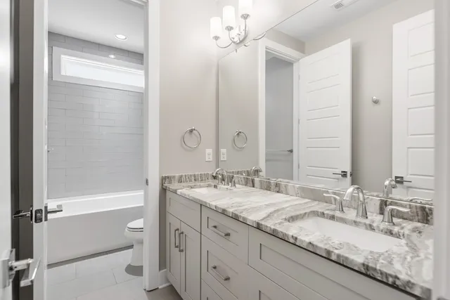 a bathroom with a sink a toilet and a bathtub