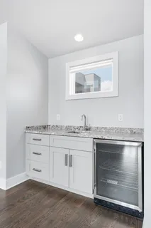 a bathroom with a granite countertop toilet and a sink