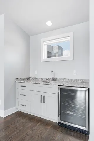 a bathroom with a granite countertop toilet and a sink