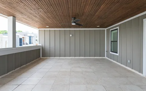 a view of a porch with a floor to ceiling window