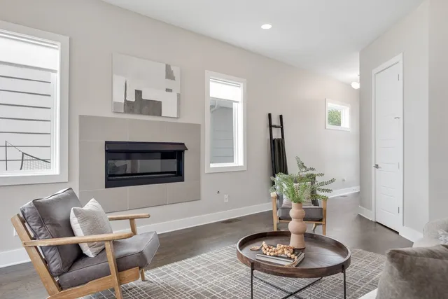 a living room with furniture potted plant and a window