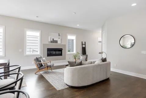 a living room with furniture wooden floor and a fireplace