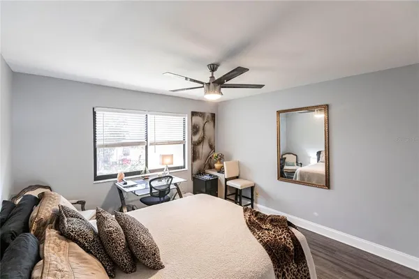 a bedroom with a bed and a painting on the wall