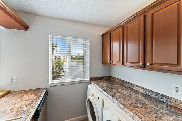 a kitchen with a stove a sink and a wooden cabinets