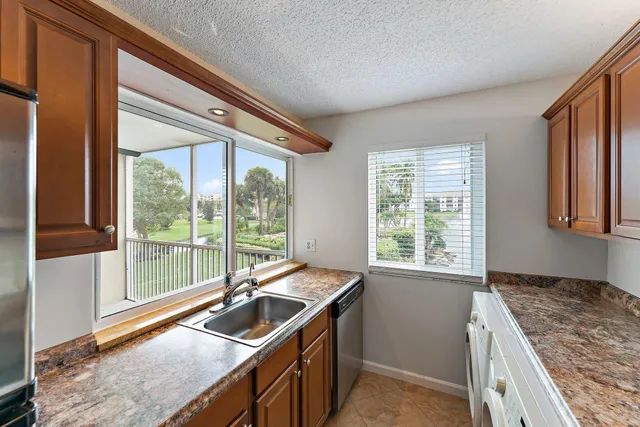 a kitchen that has a sink and a stove