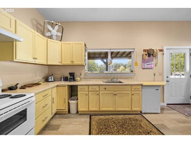 a kitchen with granite countertop a sink and cabinets