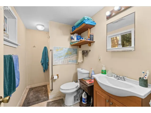 a bathroom with a sink toilet and a mirror