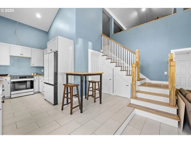 a view of kitchen with furniture and refrigerator