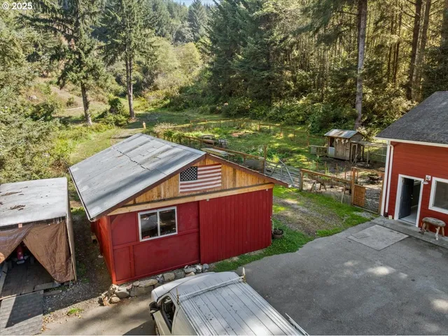 a dirt road with a house in the background