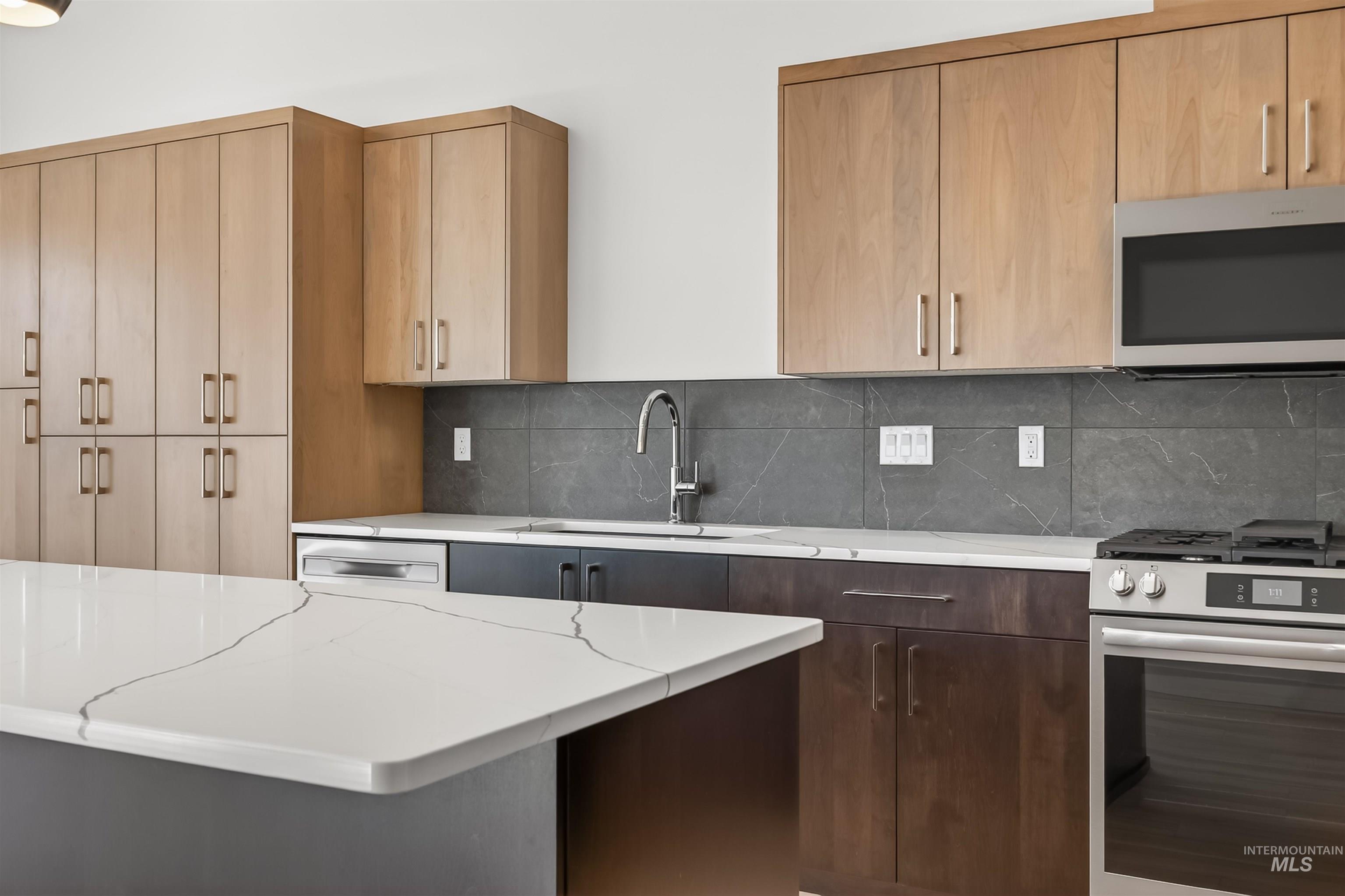 3710 22nd Street Lewiston, ID 83501 - Photo 16 of 36 Kitchen featuring stainless steel appliances, tasteful backsplash, light stone counters, and light wood finish cabinetry