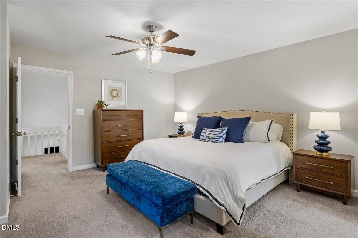 8321 Hempshire Place, Unit 103 Raleigh, NC 27613 - Photo 19 of 25 a bedroom with a bed and a chandelier