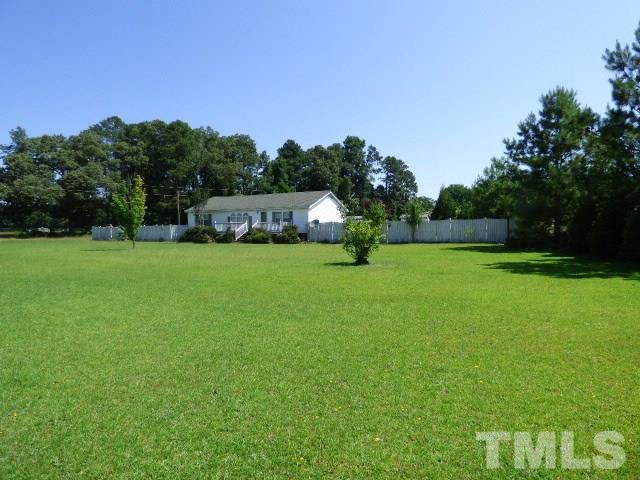 3855 Reedy Prong Church Road Dunn, NC 28334 - Photo 2 of 25 a view of a field of grass and trees