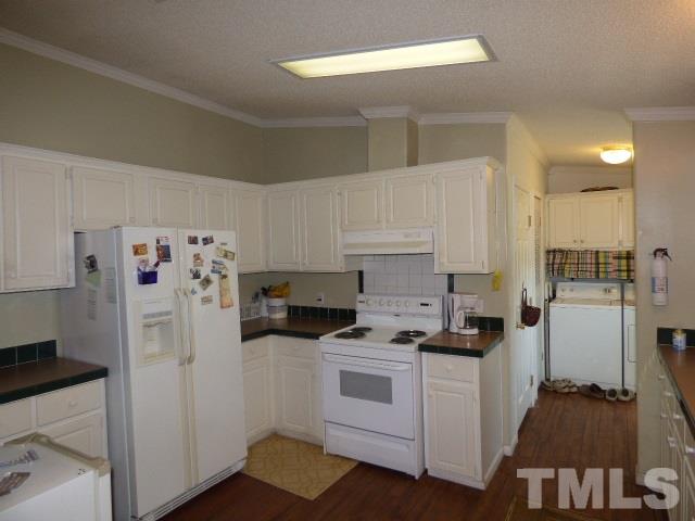 3855 Reedy Prong Church Road Dunn, NC 28334 - Photo 12 of 25 a kitchen with white cabinets and white appliances