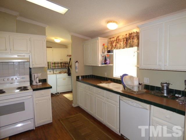 3855 Reedy Prong Church Road Dunn, NC 28334 - Photo 13 of 25 a kitchen with sink a stove and cabinets