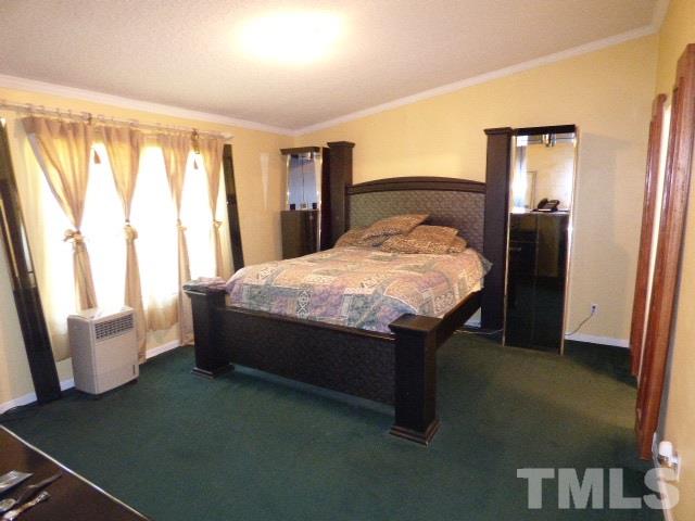 3855 Reedy Prong Church Road Dunn, NC 28334 - Photo 15 of 25 a large bed sitting in a bedroom next to a window