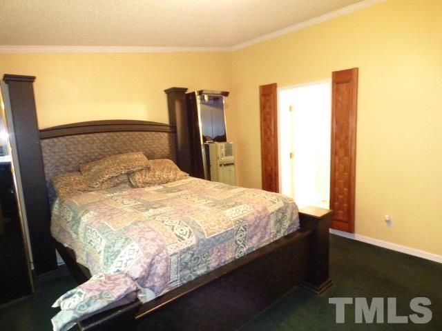 3855 Reedy Prong Church Road Dunn, NC 28334 - Photo 16 of 25 a bedroom with a bed and a night stand