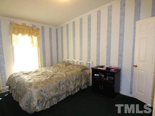 3855 Reedy Prong Church Road Dunn, NC 28334 - Photo 18 of 25 a bed sitting in a bedroom next to a window