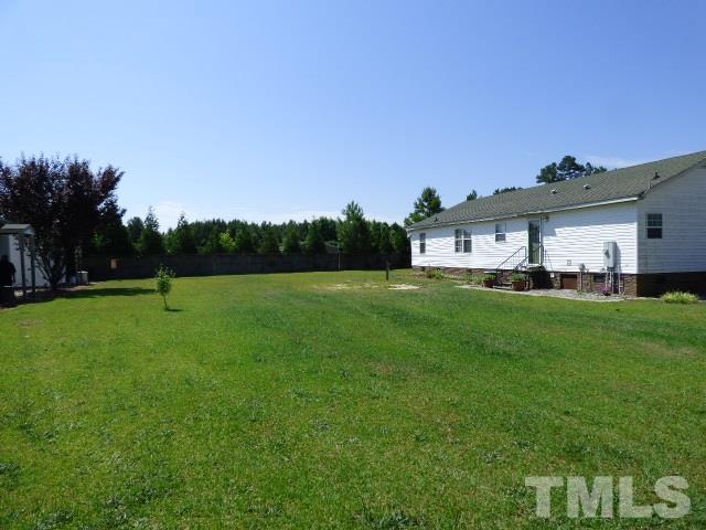 3855 Reedy Prong Church Road Dunn, NC 28334 - Photo 20 of 25 a view of house with a big yard