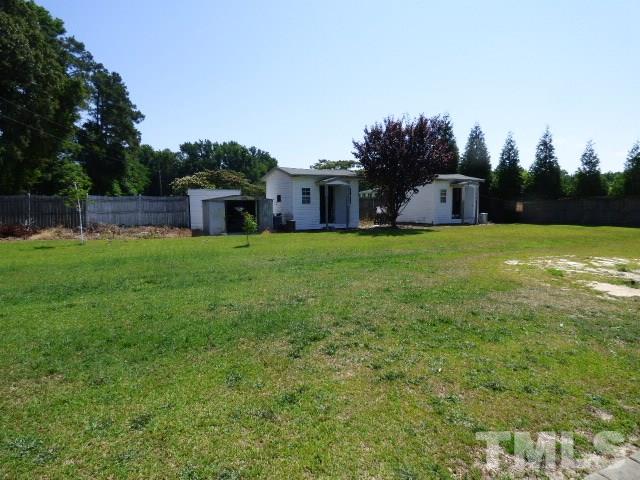 3855 Reedy Prong Church Road Dunn, NC 28334 - Photo 22 of 25 a front view of a house with a yard and trees
