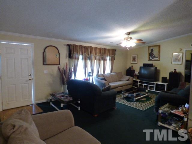 3855 Reedy Prong Church Road Dunn, NC 28334 - Photo 7 of 25 a living room with furniture a large window and a flat screen tv