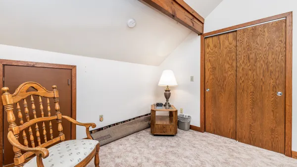 a living room with furniture a flat screen tv and a couch