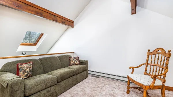 a living room with furniture and a baby crib