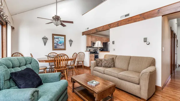 a living room with furniture and a wooden floor