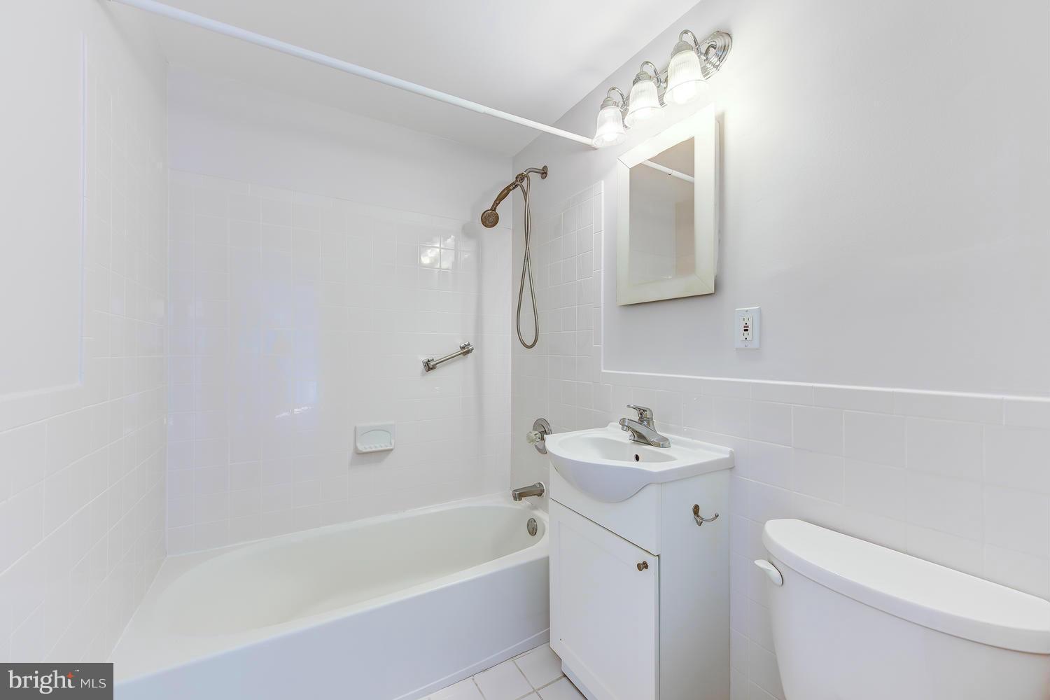 1311 Delaware Avenue Southwest, Unit S131 Washington, DC 20024 - Photo 18 of 18 a bathroom with a sink a toilet and shower