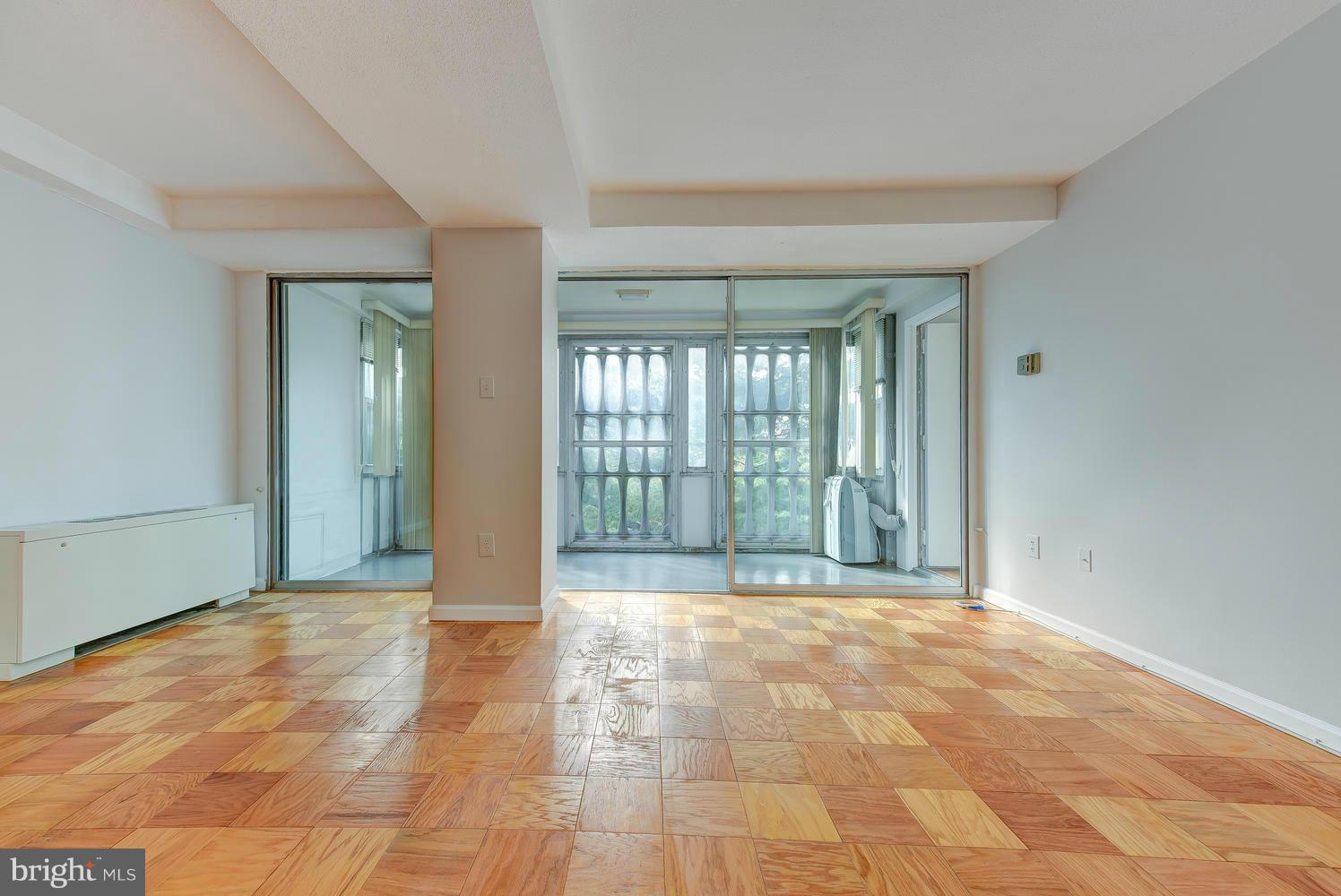 1311 Delaware Avenue Southwest, Unit S131 Washington, DC 20024 - Photo 4 of 18 a view of a big room with windows and chandelier fan