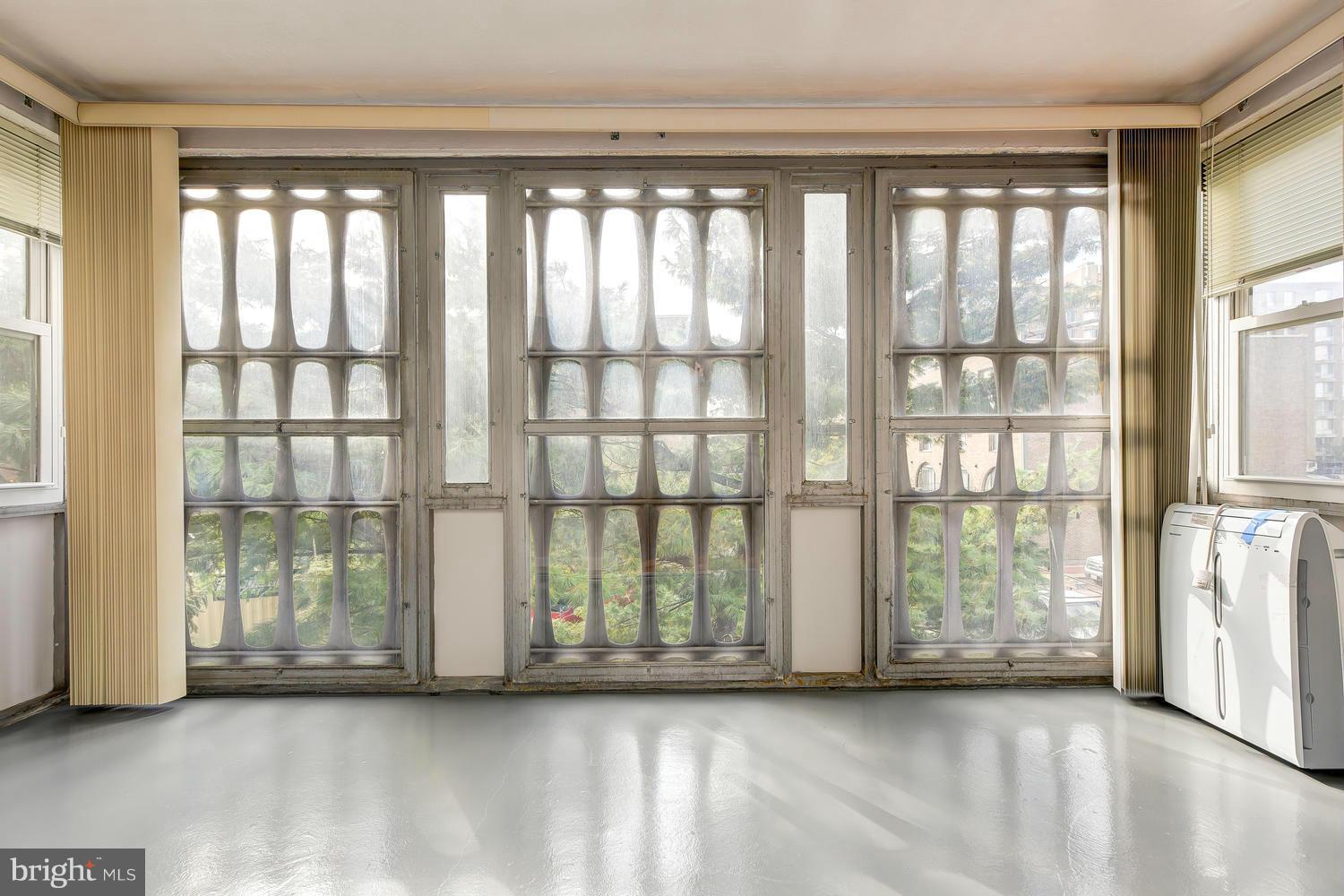 1311 Delaware Avenue Southwest, Unit S131 Washington, DC 20024 - Photo 5 of 18 a view of room with floor to ceiling windows and an outdoor view