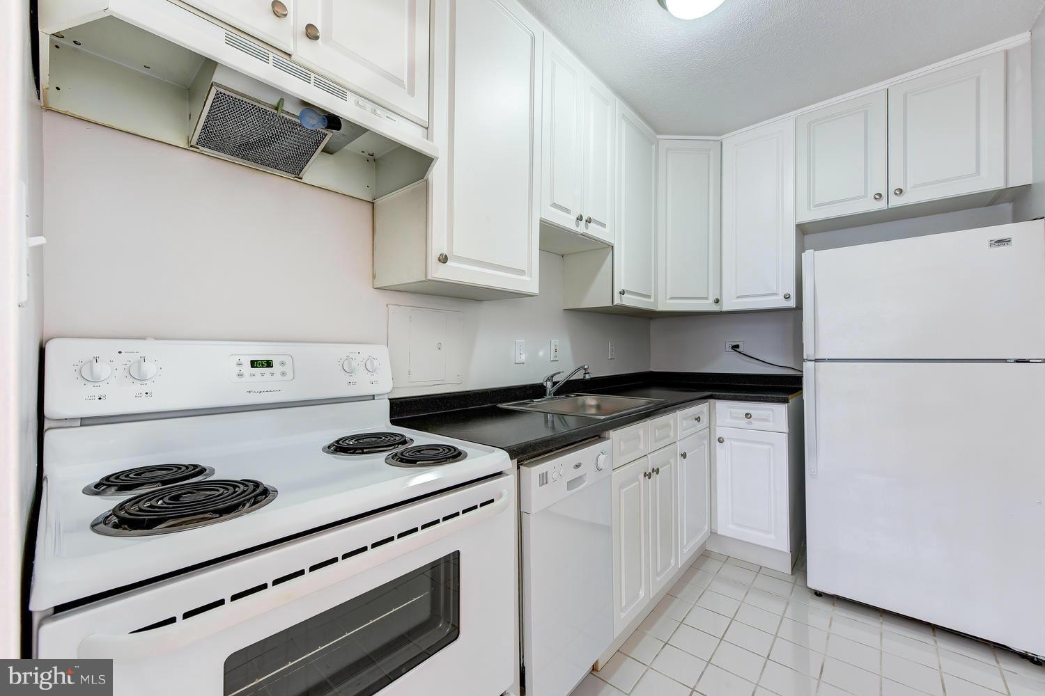1311 Delaware Avenue Southwest, Unit S131 Washington, DC 20024 - Photo 10 of 18 a kitchen with cabinets appliances a sink and a stove