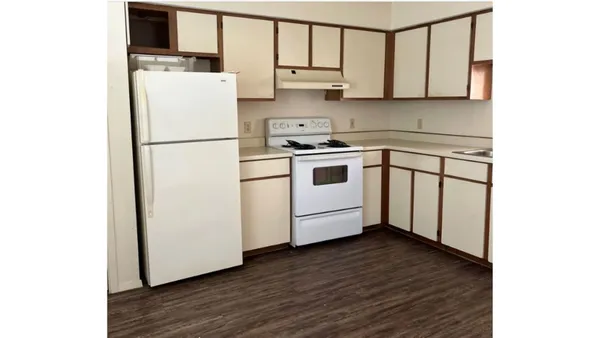 a kitchen with a white cabinets and white appliances