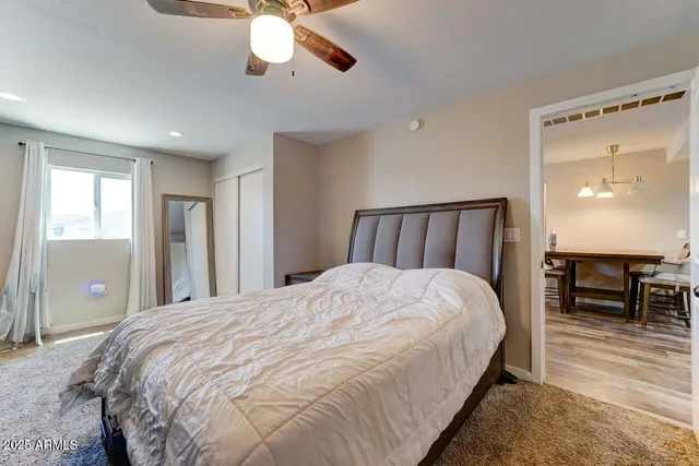 a bedroom with a large bed and a chandelier