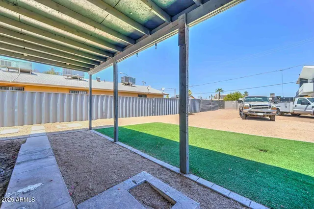 a view of backyard with swimming pool and seating