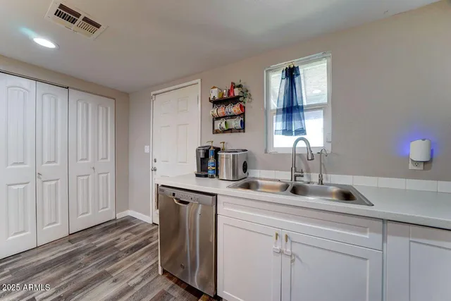 a kitchen with a sink and cabinets