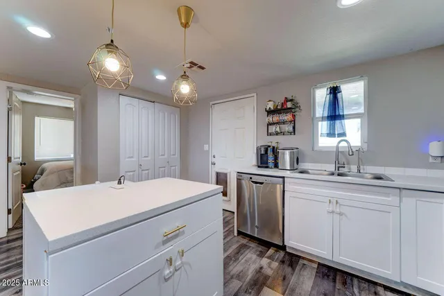 a kitchen that has a sink and a stove in it