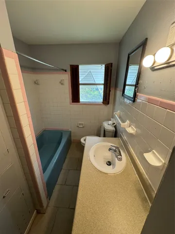 a bathroom with a sink a toilet and a mirror